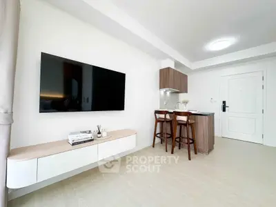 Modern minimalist living room with wall-mounted TV and stylish kitchen bar