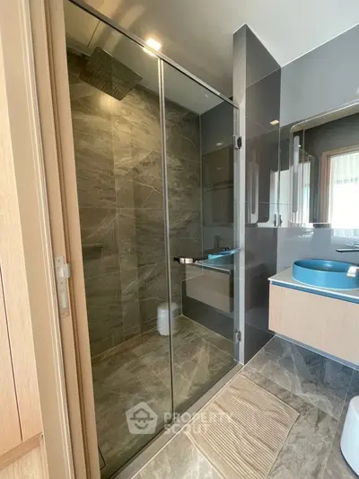Modern bathroom with glass shower and stylish fixtures