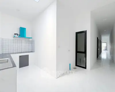 Modern minimalist kitchen with sleek white cabinetry and open layout