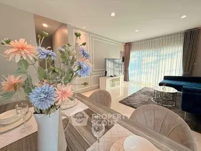 Elegant living room with modern decor, large windows, and stylish furniture, perfect for relaxation.