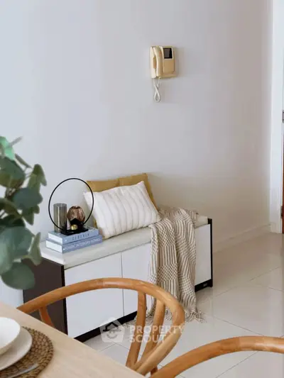 Chic modern interior with cozy seating and stylish decor in a bright living space.