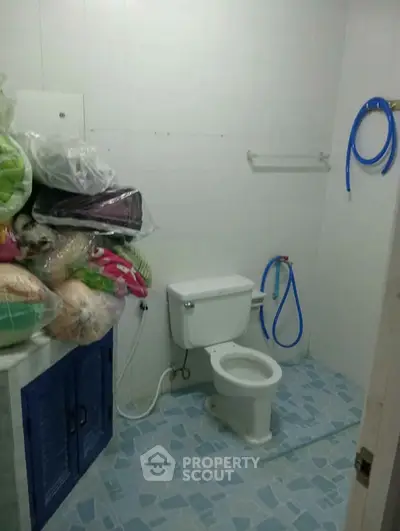 Compact bathroom with toilet and storage space, ideal for small apartments.