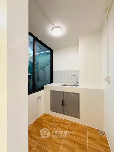 Modern kitchen with sleek design and large window for natural light