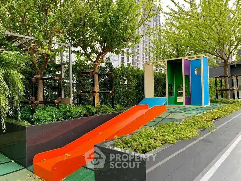 Modern outdoor playground with vibrant slide and lush greenery in urban setting