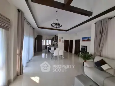 Spacious open-plan living and dining area with modern decor and natural light.