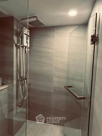 Modern bathroom with sleek glass shower and contemporary fixtures.