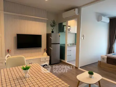 Modern open-plan living room with kitchen and bedroom, featuring sleek design and air conditioning.