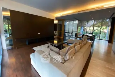 Spacious modern living room with large windows and elegant decor