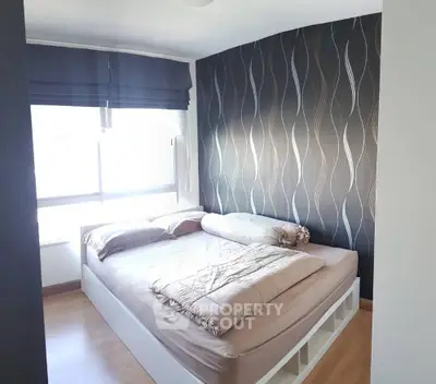 Modern bedroom with stylish wallpaper and natural light