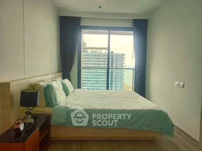 Modern bedroom with large window offering stunning city view in high-rise apartment.