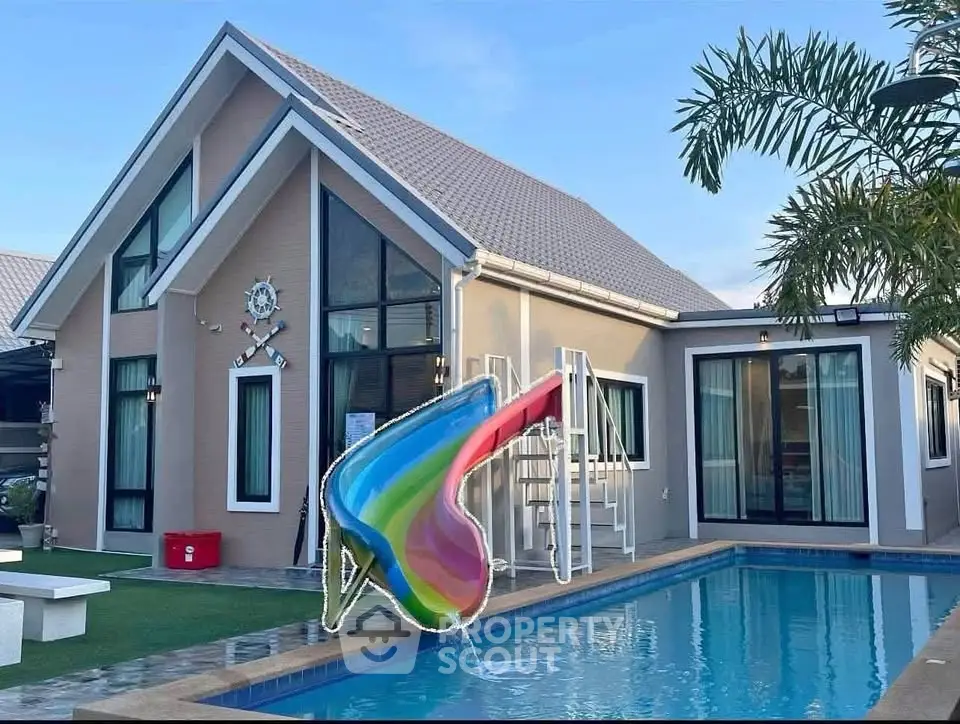 Stunning modern house with pool and colorful slide, perfect for family fun and relaxation.