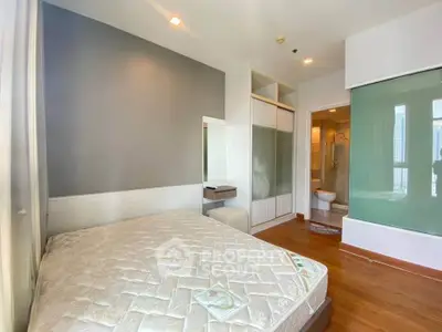 Modern bedroom with ensuite bathroom and built-in wardrobe in a stylish apartment.