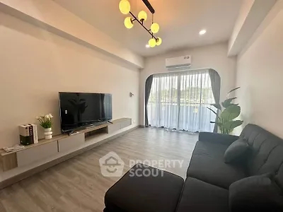 Modern living room with sleek furniture and large window for natural light.