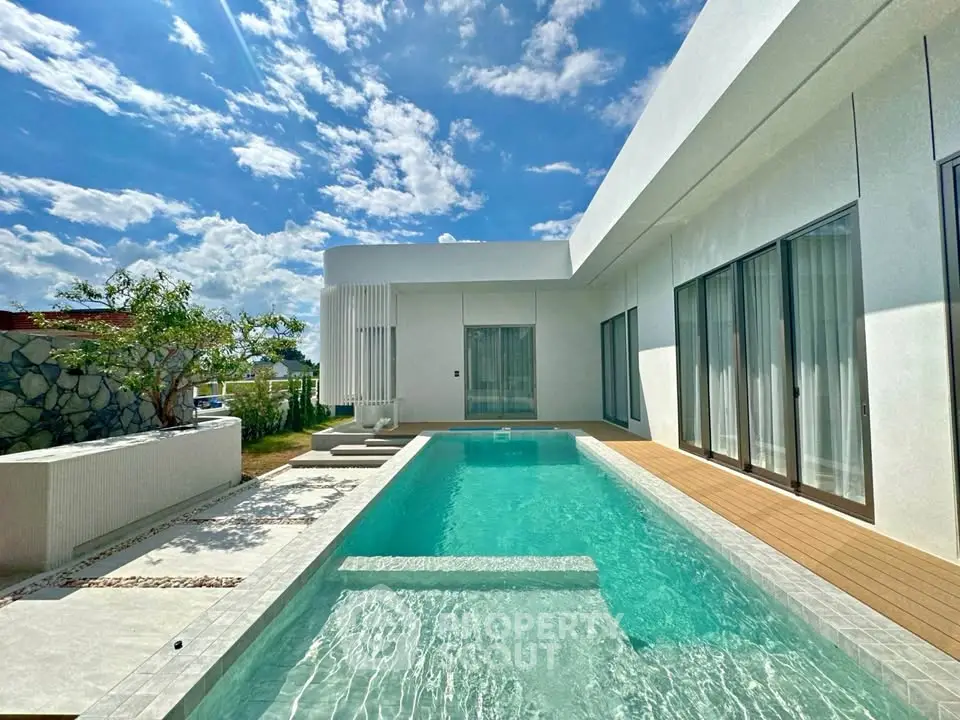 Luxurious modern villa with private pool and stunning architecture under a clear blue sky.