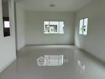 Spacious empty room with large windows and glossy tiled floor, perfect for customization.