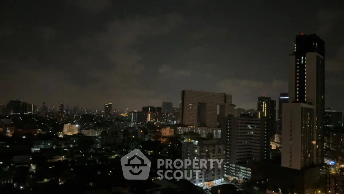 Stunning nighttime cityscape view with illuminated skyline and high-rise buildings.