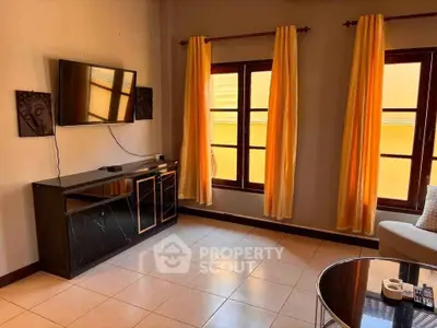 Spacious living room with modern decor and large windows for natural light.