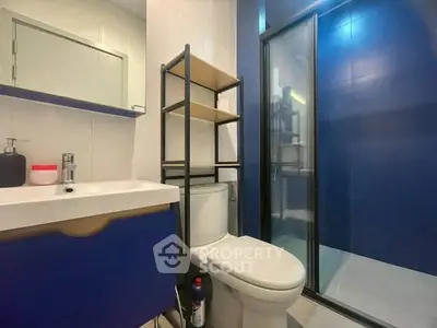 Modern bathroom with sleek blue accents and glass shower enclosure