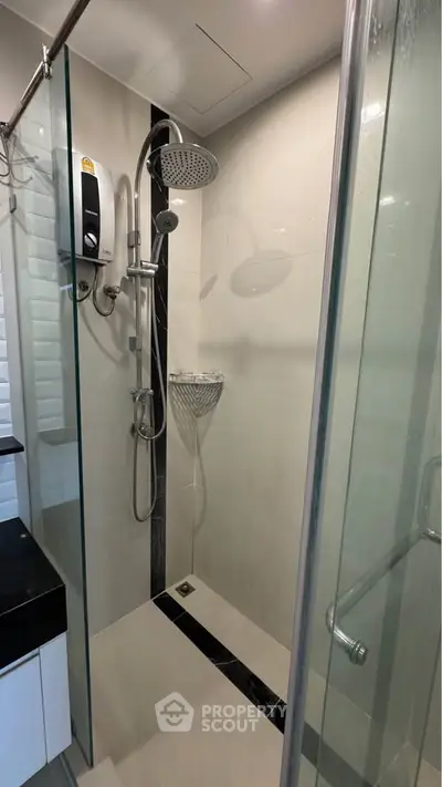 Modern bathroom with glass shower enclosure and sleek fixtures