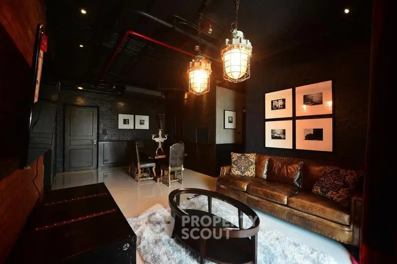 Stylish industrial-themed living room with leather sofa and modern lighting