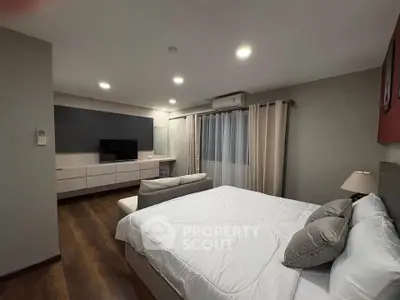 Spacious modern bedroom with elegant decor and cozy ambiance