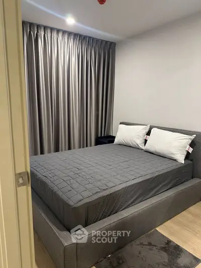 Modern bedroom with gray decor and elegant curtains