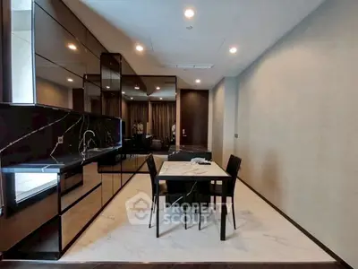 Modern dining area with sleek black cabinetry and marble flooring