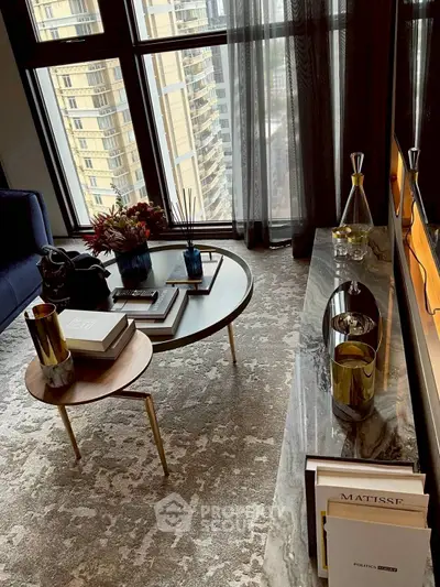 Luxurious living room with elegant decor and stunning city view from large windows.