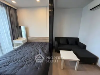 Modern studio apartment with cozy bed and stylish living area