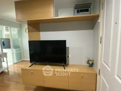 Modern living room with sleek TV unit and wooden flooring