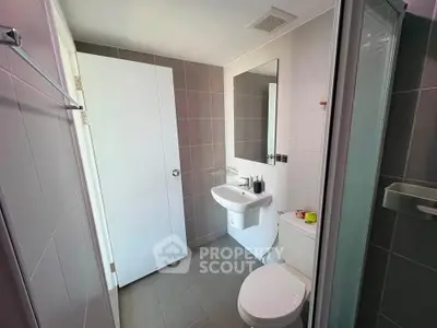 Modern bathroom with sleek fixtures and neutral tiles, perfect for a contemporary home.