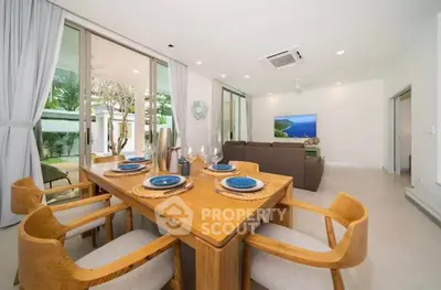 Spacious modern living room with elegant dining area and large windows for natural light.