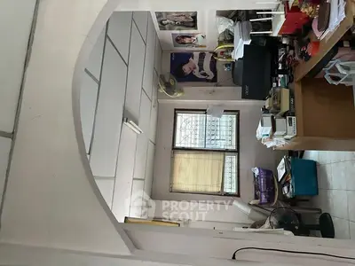 Cozy home office with desk, computer, and fan, ideal for productivity.
