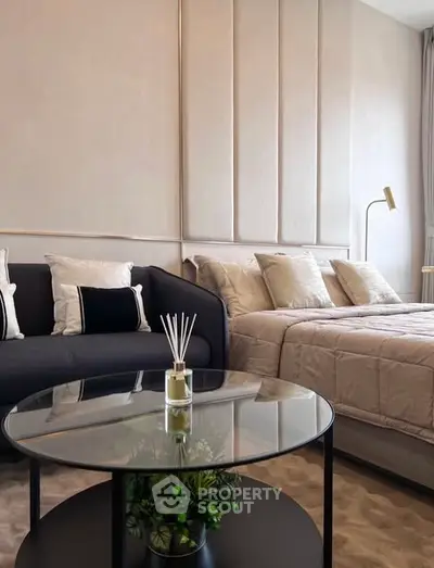 Modern bedroom with stylish decor and cozy seating area, perfect for relaxation.