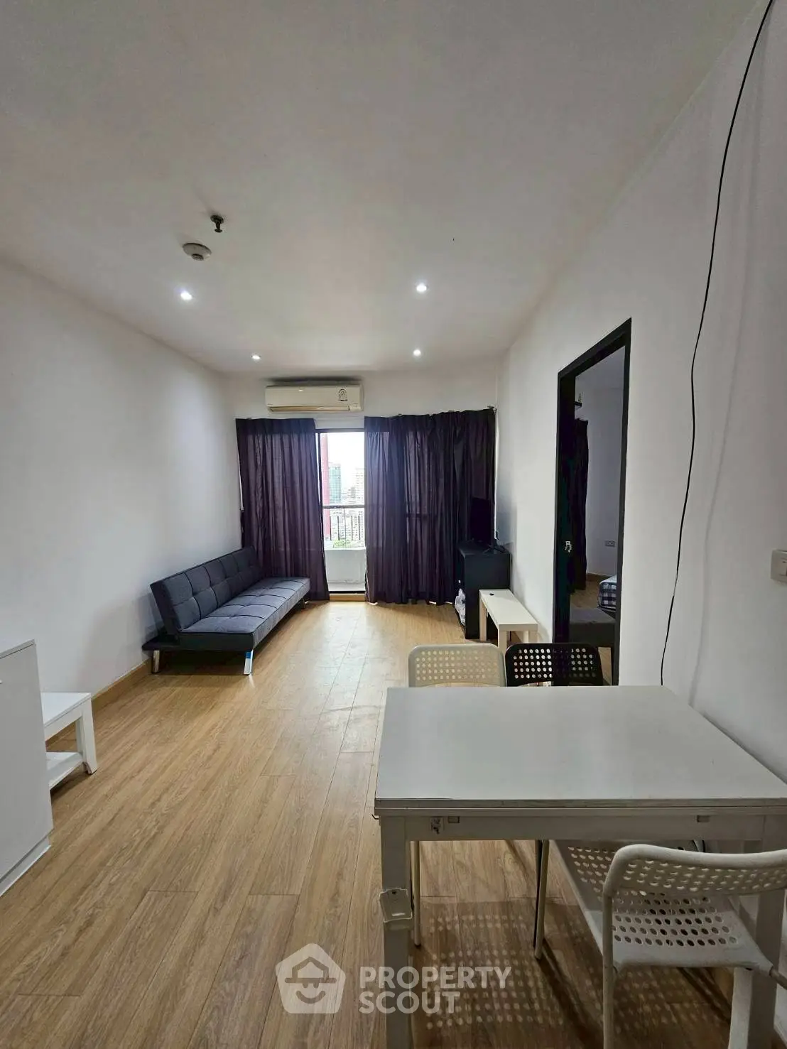 Spacious living room with modern furniture and wooden flooring