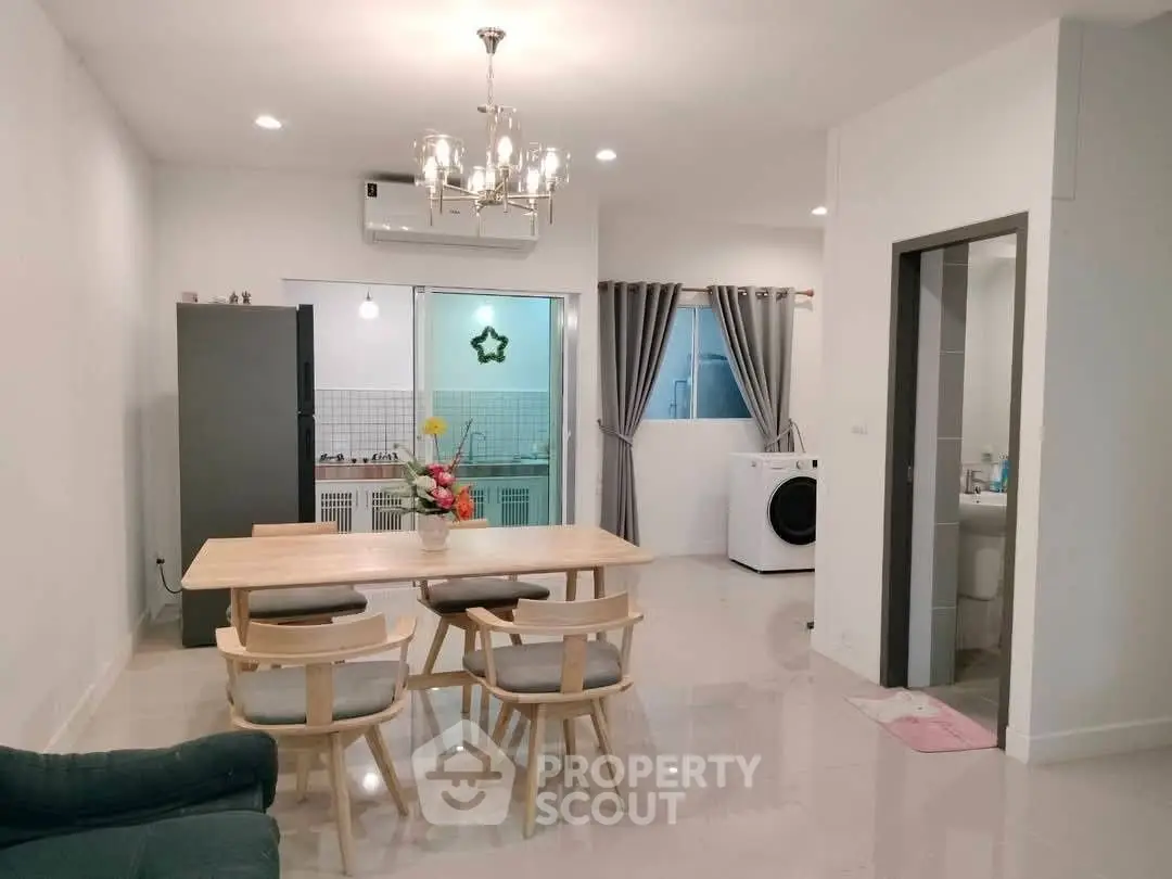 Modern open-layout dining area with stylish furniture and kitchen view