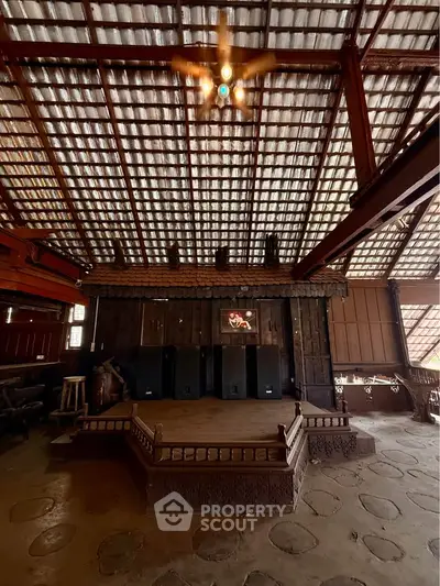 Rustic interior with wooden beams and unique ceiling design, showcasing traditional architecture.