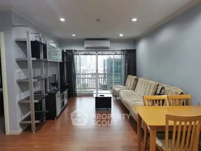 Spacious living room with city view, modern furniture, and wooden flooring in urban apartment.
