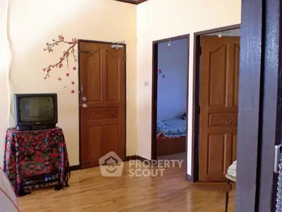 Charming interior with wooden doors and vintage TV in cozy living space.