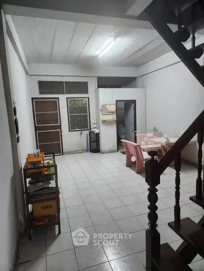 Spacious interior with dining area and staircase, ideal for cozy family gatherings.