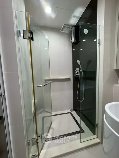 Modern bathroom with glass shower enclosure and sleek fixtures