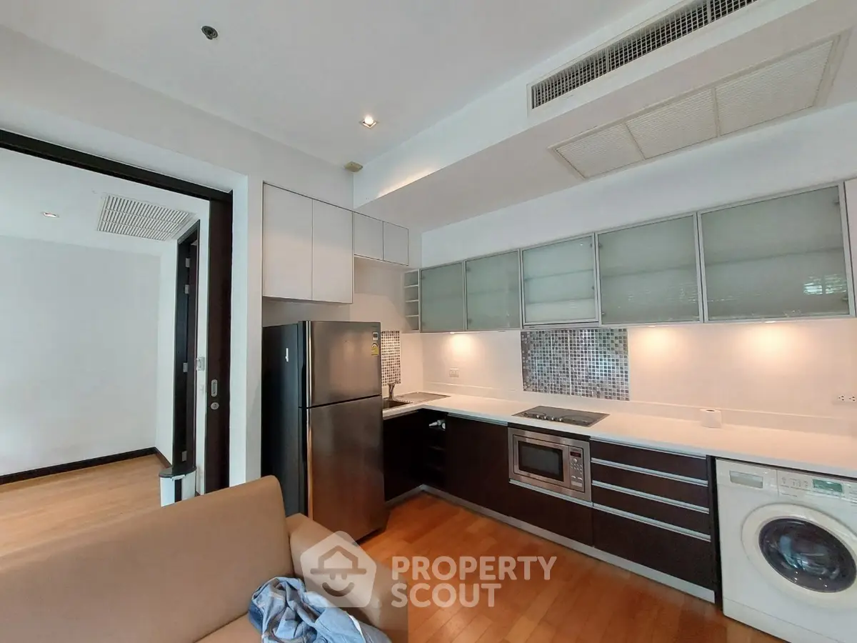 Modern kitchen with sleek appliances and open layout in stylish apartment