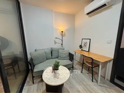 Cozy study room with modern sofa, desk, and air conditioning