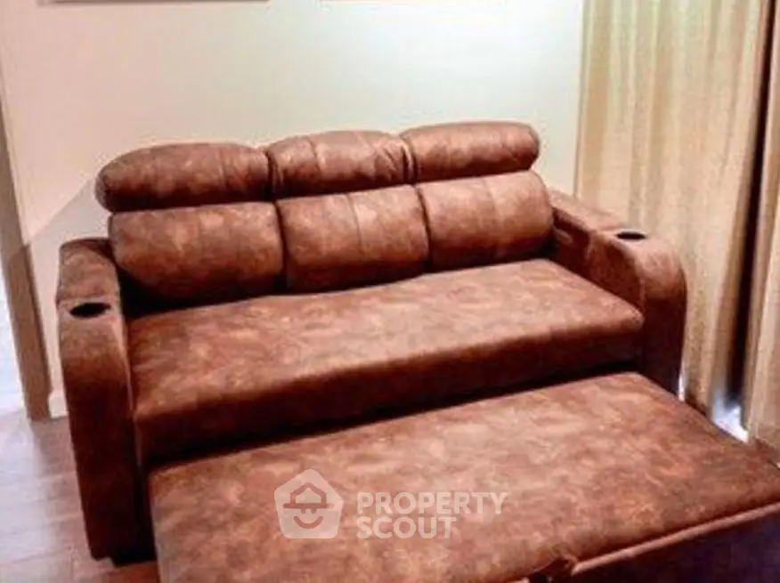 Cozy brown leather sofa bed in a stylish living room setting.