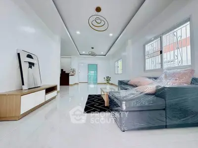 Spacious modern living room with sleek furniture and elegant lighting, perfect for family gatherings.