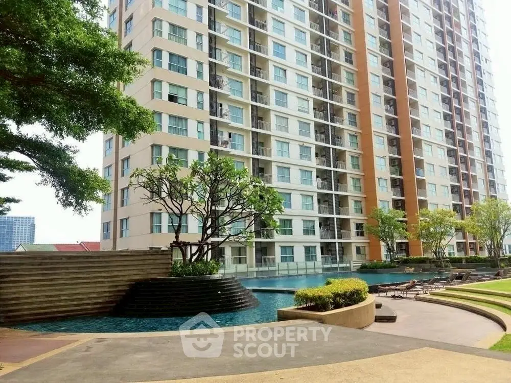 Luxurious high-rise apartment with stunning pool and landscaped garden view.