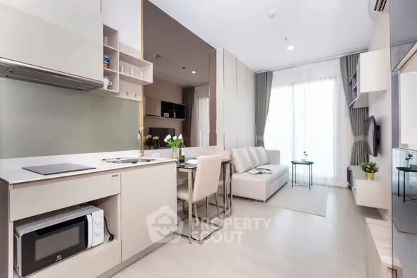 Modern open-plan living room with kitchen, bright and stylish interior design.