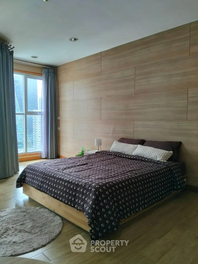 Modern bedroom with wooden accents and city view window