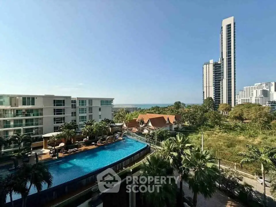 Stunning high-rise view with pool and lush greenery, perfect for luxury living.