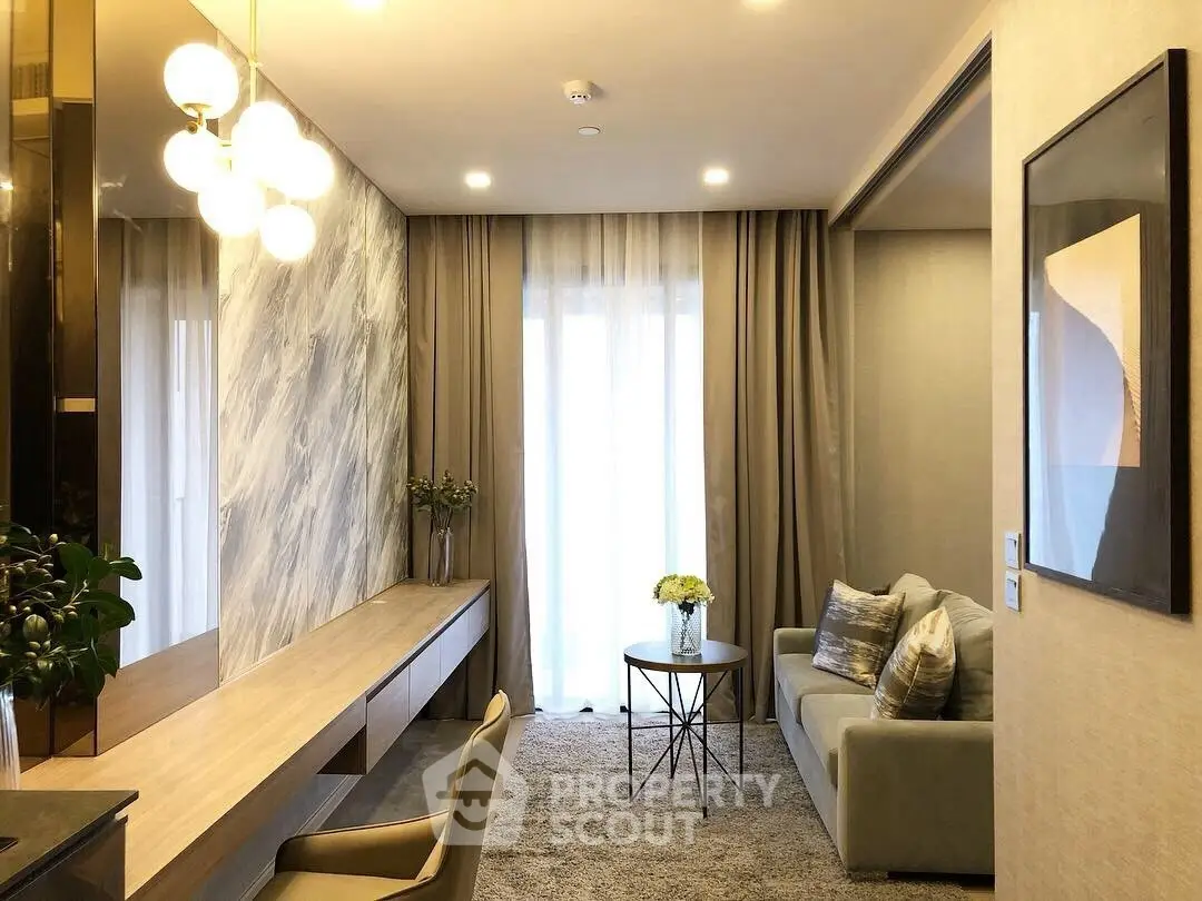 Elegant living room with modern decor, featuring a cozy sofa, stylish lighting, and a chic marble accent wall.
